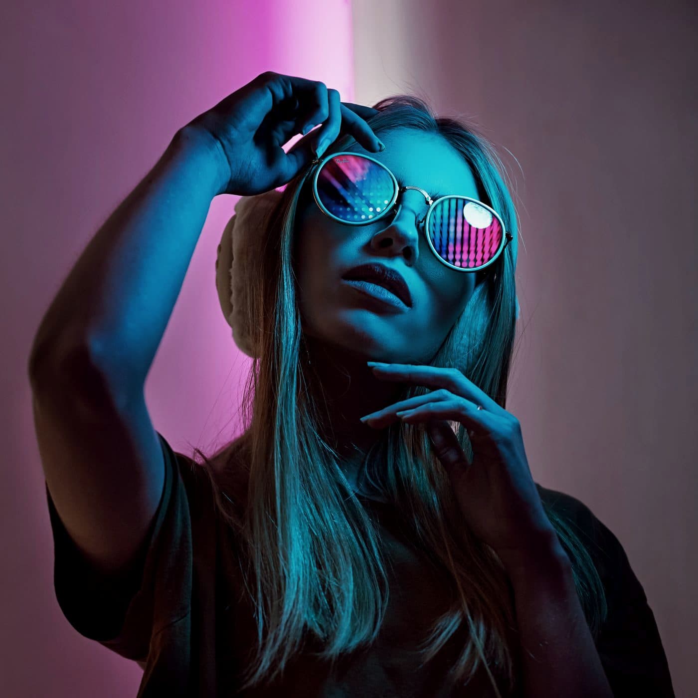 Still from Glass Hours: sunglasses in pink and cyan light.