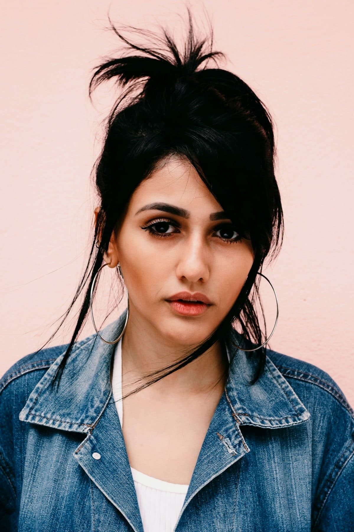 Close face, hair forward, looking past the camera.